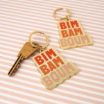 porte-clés graphisme "bim bam boum" dégradé de couleur orange